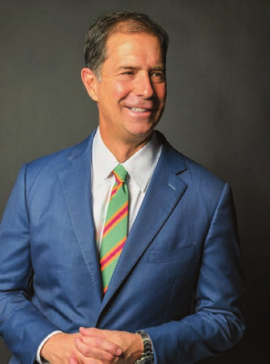Headshot of Cam Marston in a suit