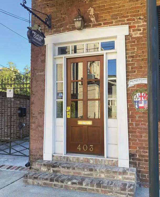 Custom wooden door at a historic brick building on Conti Street in Downtown Mobile