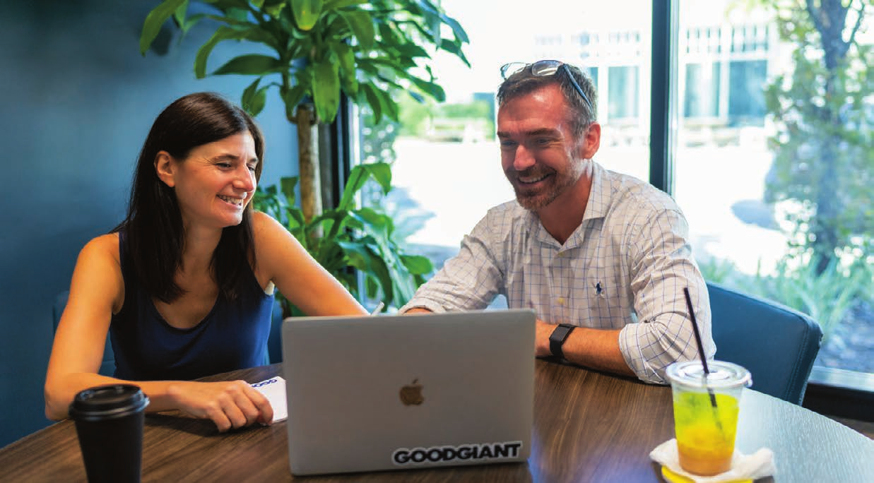 Two Good Giant Mobile office staff members, a woman and a man, working together on a laptop