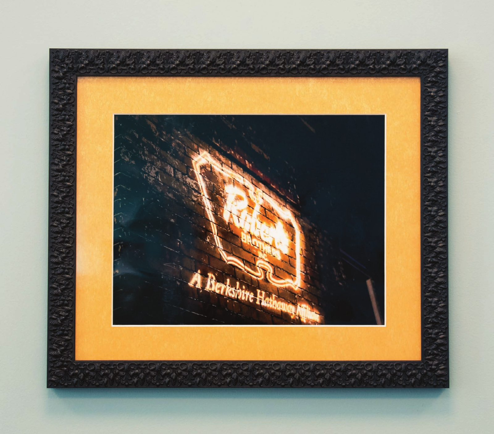 Framed photograph of the Roberts Brothers neon sign on a brick wall, A Berkshire Hathaway affiliate