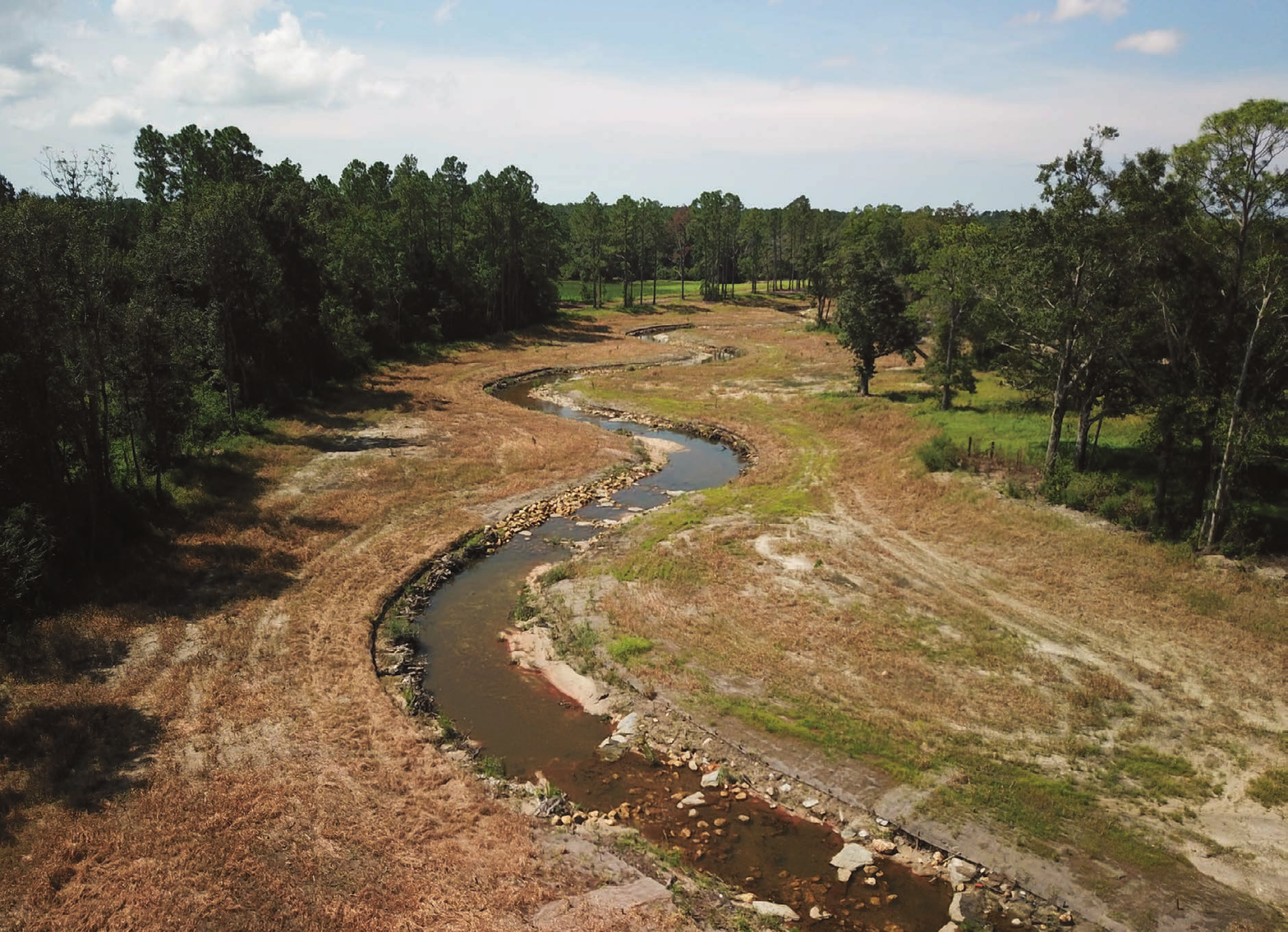 Aerial view of a restored meandering stream and floodplain on Schoolhouse Branch in the Magnolia River Watershed.