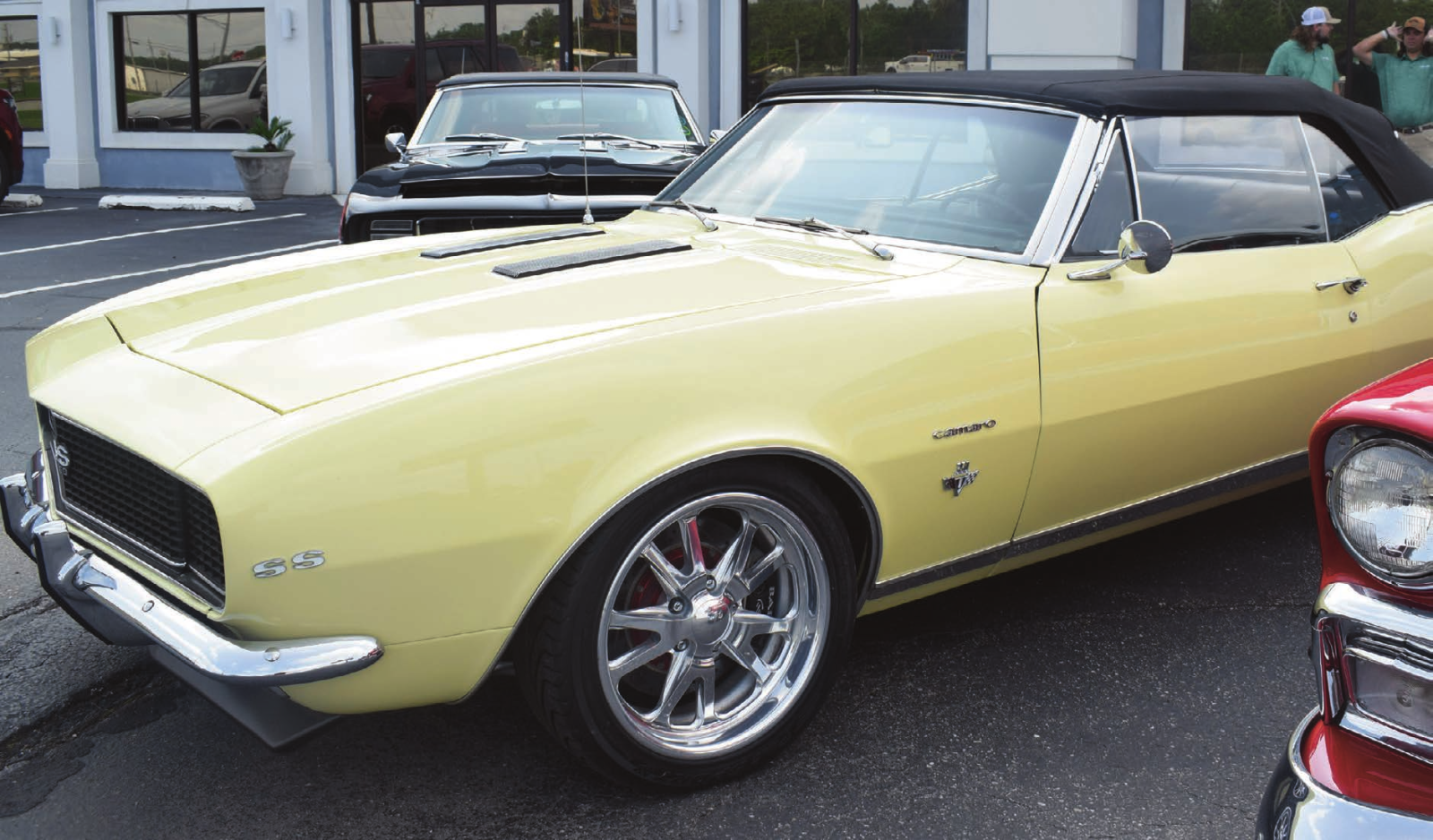 Yellow classic Camaro SS convertible parked outdoors