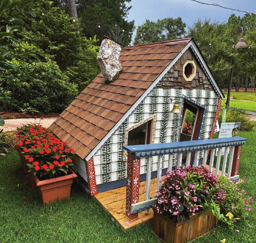 The Wonky House, a whimsical small cottage structure in the garden