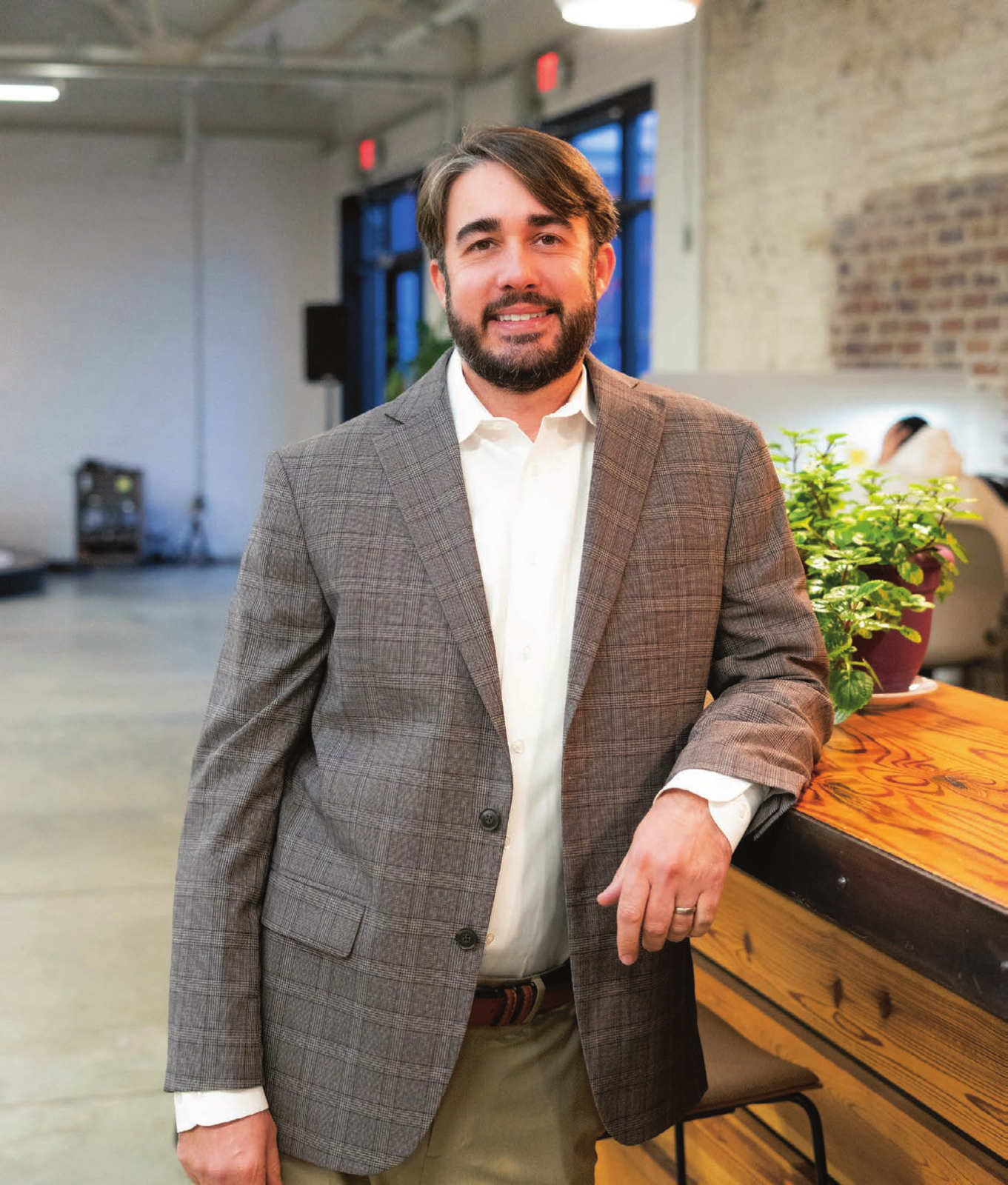 Jason Kudulis, director of MBNEP, standing indoors in a blazer.