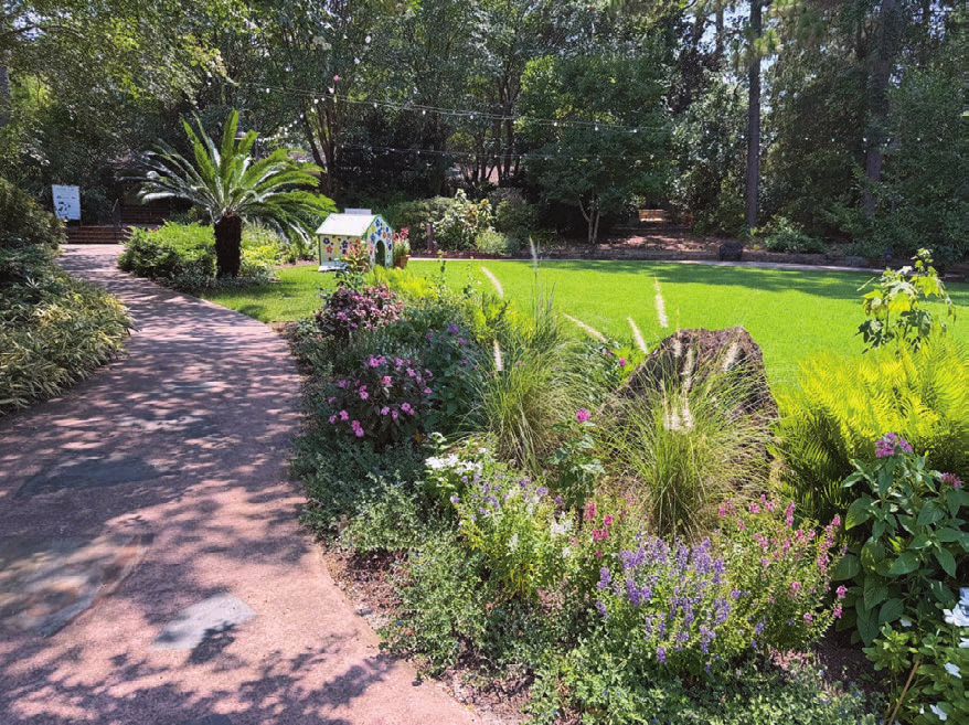 The ReBloom Garden with colorful plantings and a green lawn at Mobile Botanical Gardens