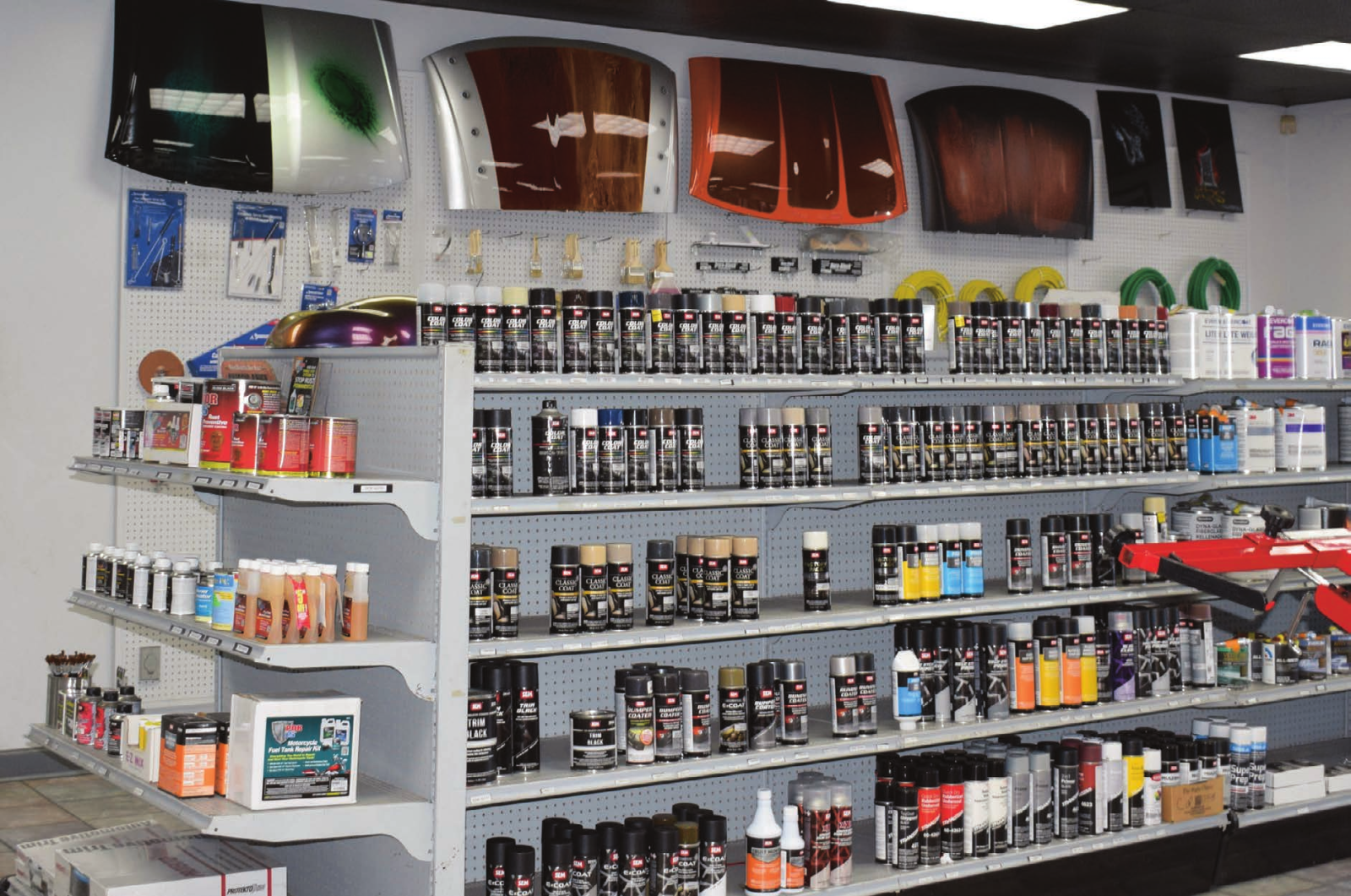 Well-stocked shelves of automotive paint supplies and aerosol cans at APS Mobile location