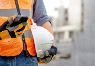 Construction,Worker,Man,With,Orange,Reflective,Vest,Holding,White,Protective
