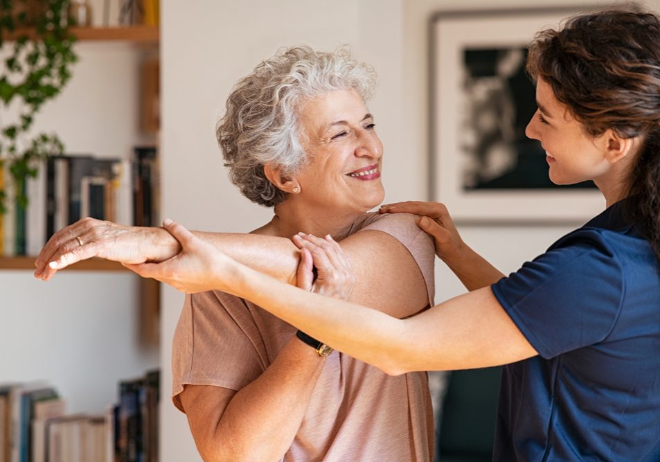 Happy,Senior,Woman,Doing,Exercise,At,Home,With,Physiotherapist.,Old